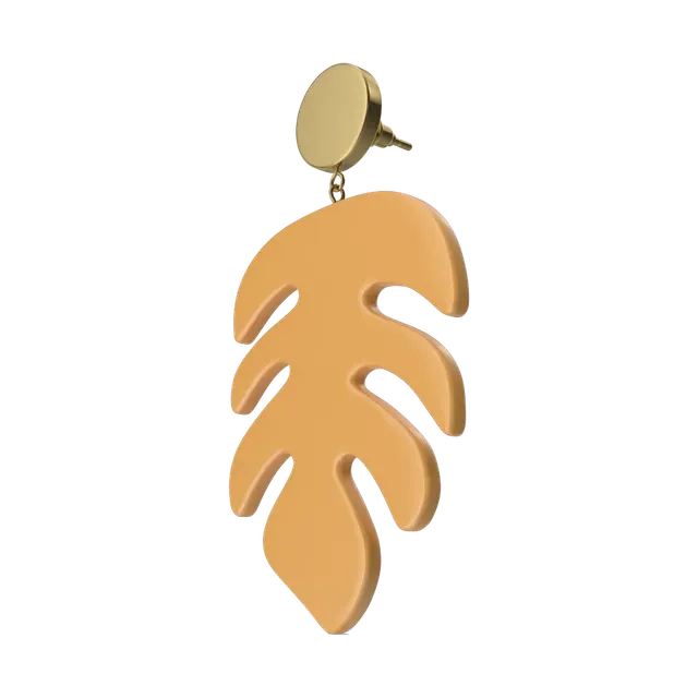 Gold-tone monstera leaf drop earrings, angled view