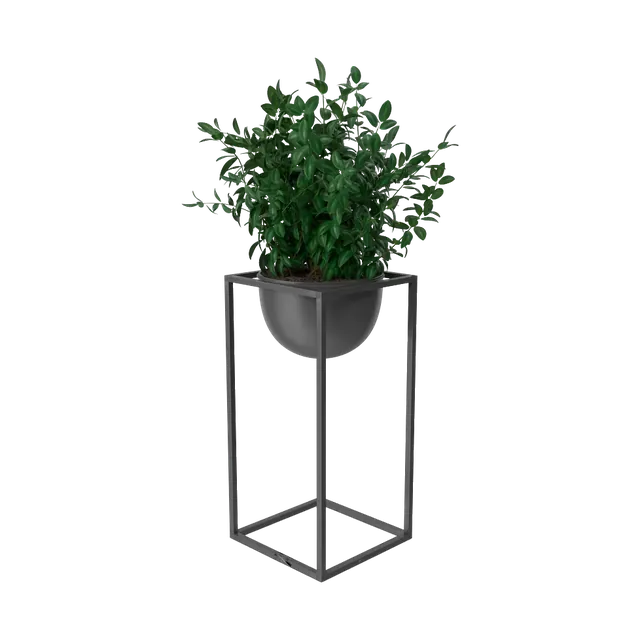 Artificial boxwood plant in a black bowl on a tall metal stand, side view